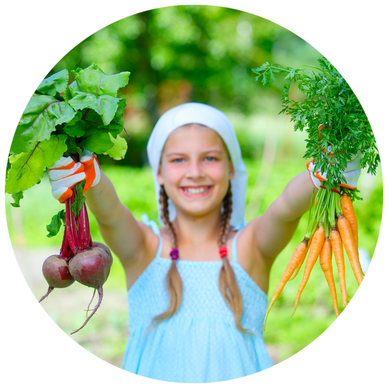 girl holding garden vegetables