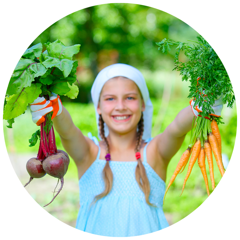 girl holding garden vegetables