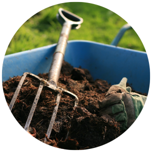 pitchfork in soil in garden bed