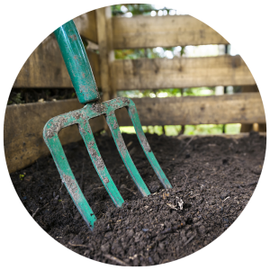 pitchfork in garden bed soil
