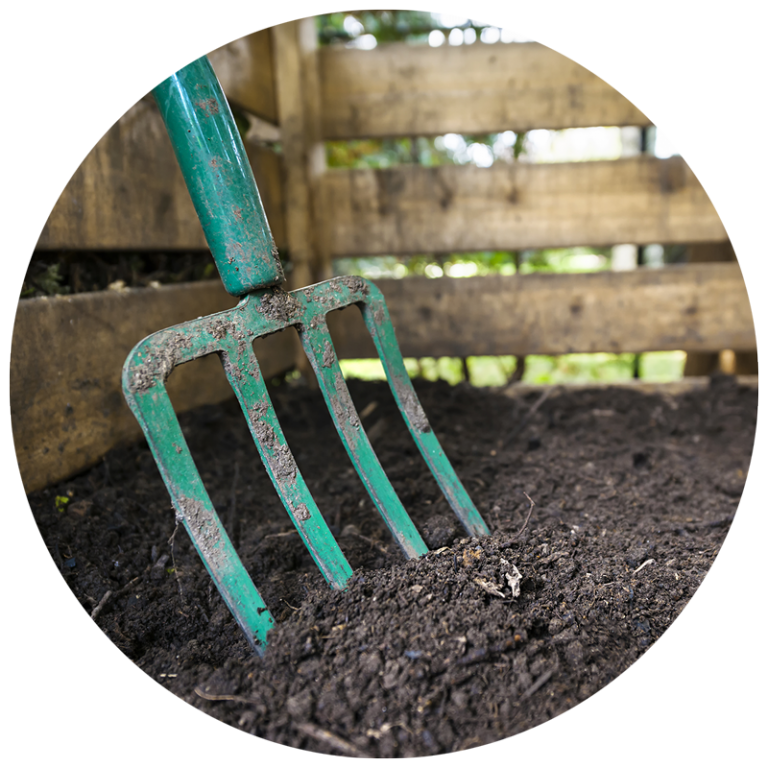 pitchfork in garden bed soil