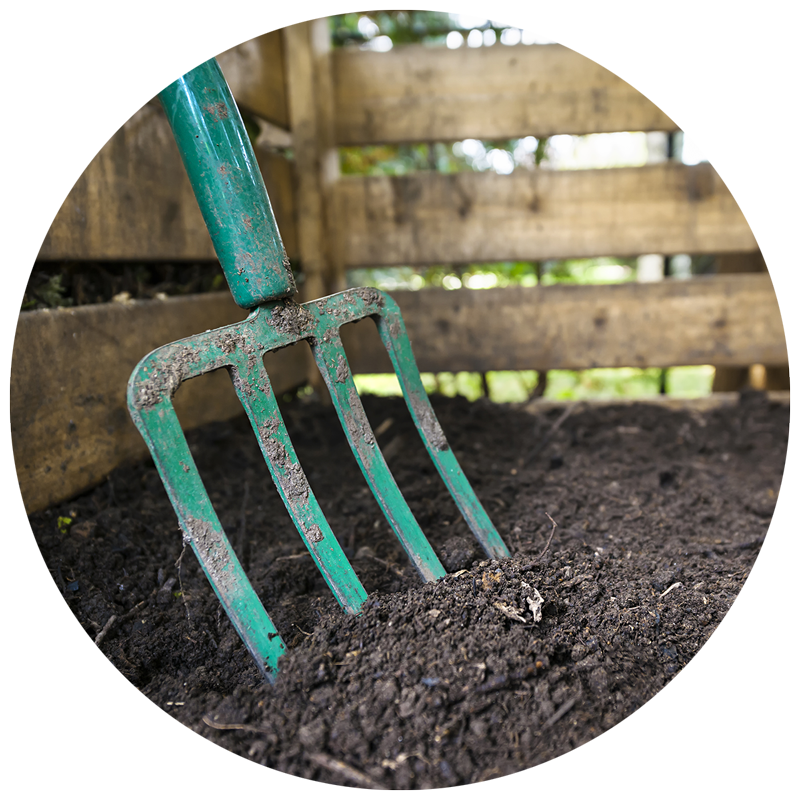 pitchfork in garden bed soil