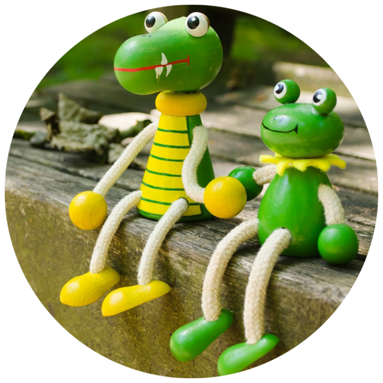 small wooden frog and crocodile figurines sitting in a pirate's garden