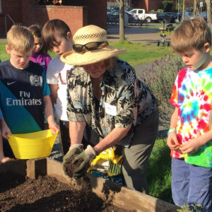 Miss Judy in the garden with kids
