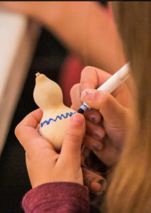 child drawing on small gourd