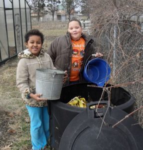 Two kids composting