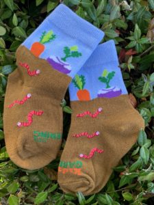 Small socks with worms, soil, carrots, and turnips