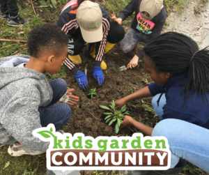 Kids gather around an educator in the garden, a logo reading "kids garden COMMUNITY" is at the bottom of the image