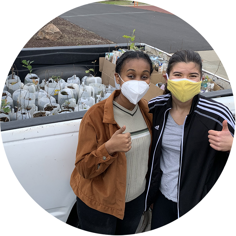 Project Climate Club members with oak tree seedlings in the cab of a truck.