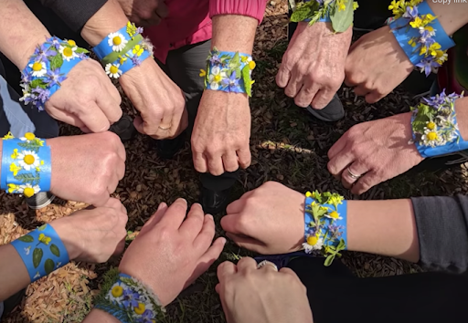 hands wearing garden tape bracelets with flowers