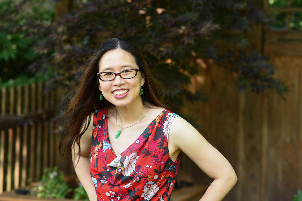 Grace Lin wearing a red top in her garden
