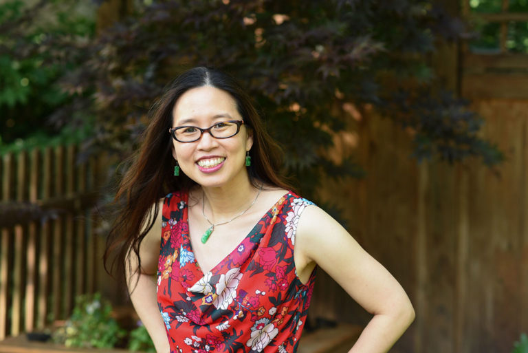 Grace Lin wearing a red top in her garden