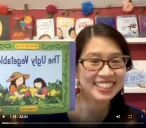 A screenshot of Grace Lin holding up her book The Ugly Vegetables