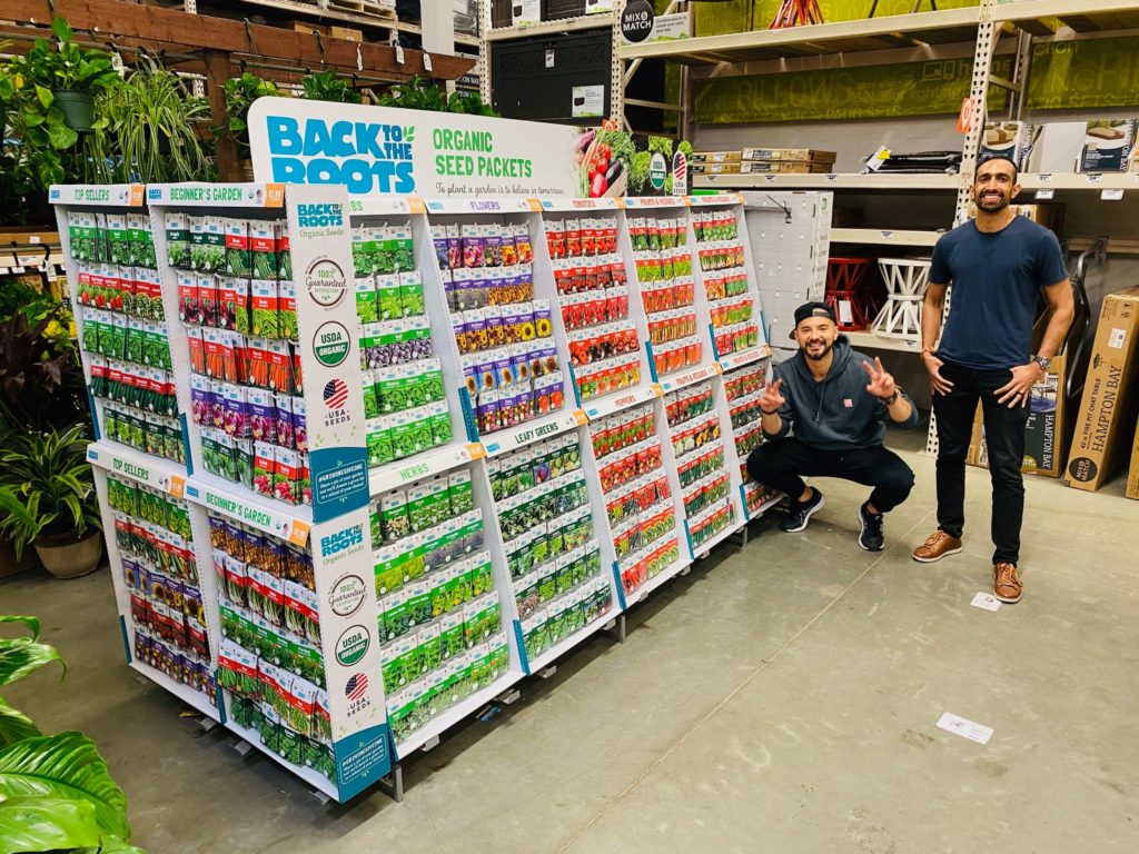 Alex and Nikhil posing with their Back to the roots seeds in a store