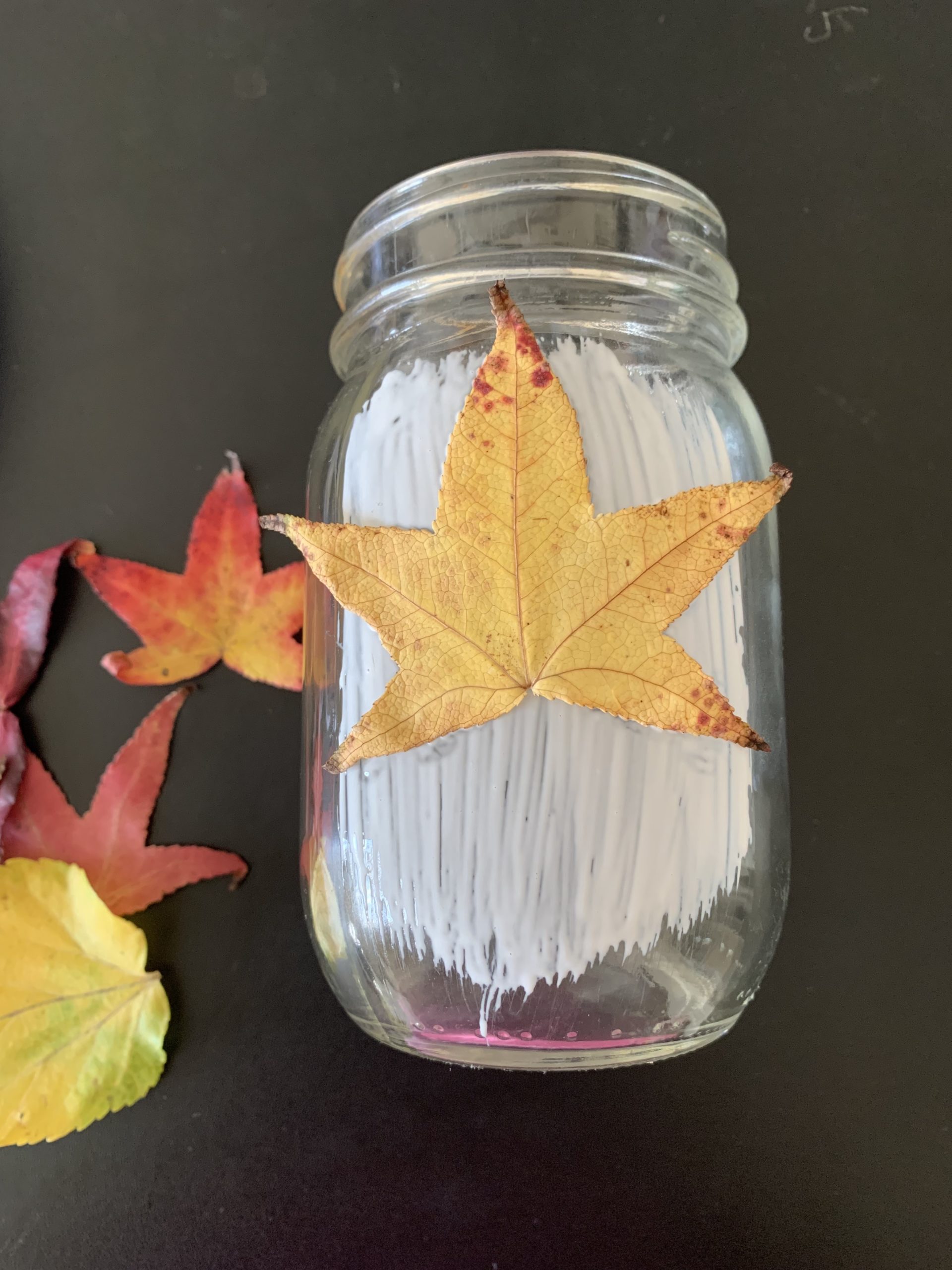 A yellow leaf glued on a mason jar