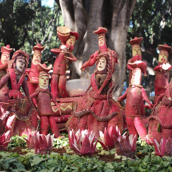 Radishes carved elaborately to look like people