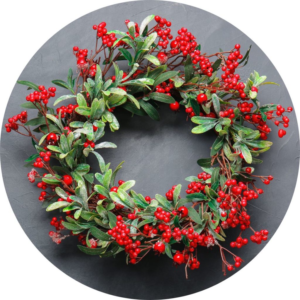 A wreath made of green leaves and red berries