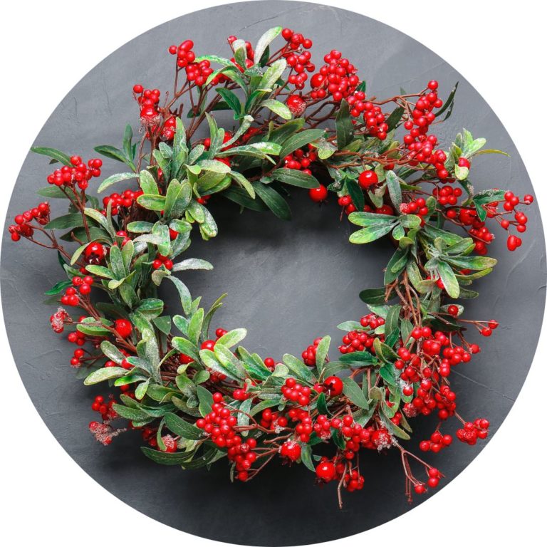 A wreath made of green leaves and red berries