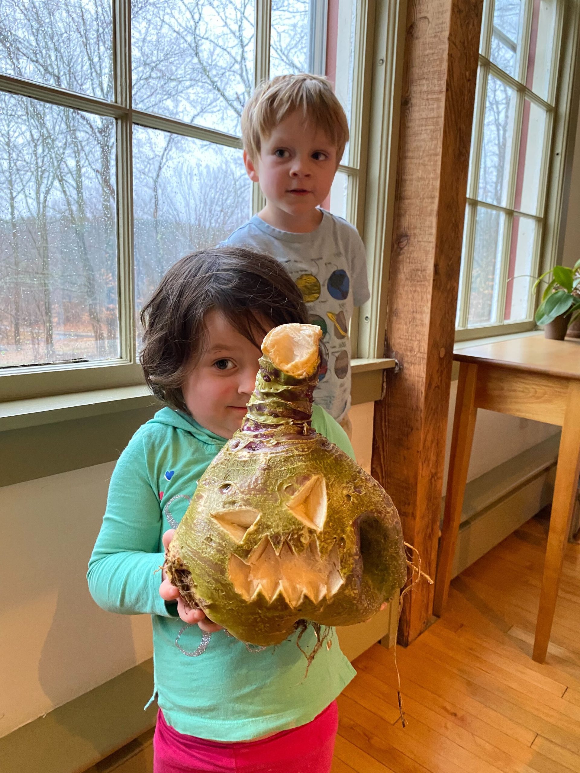 Two young kids with a carved gourd