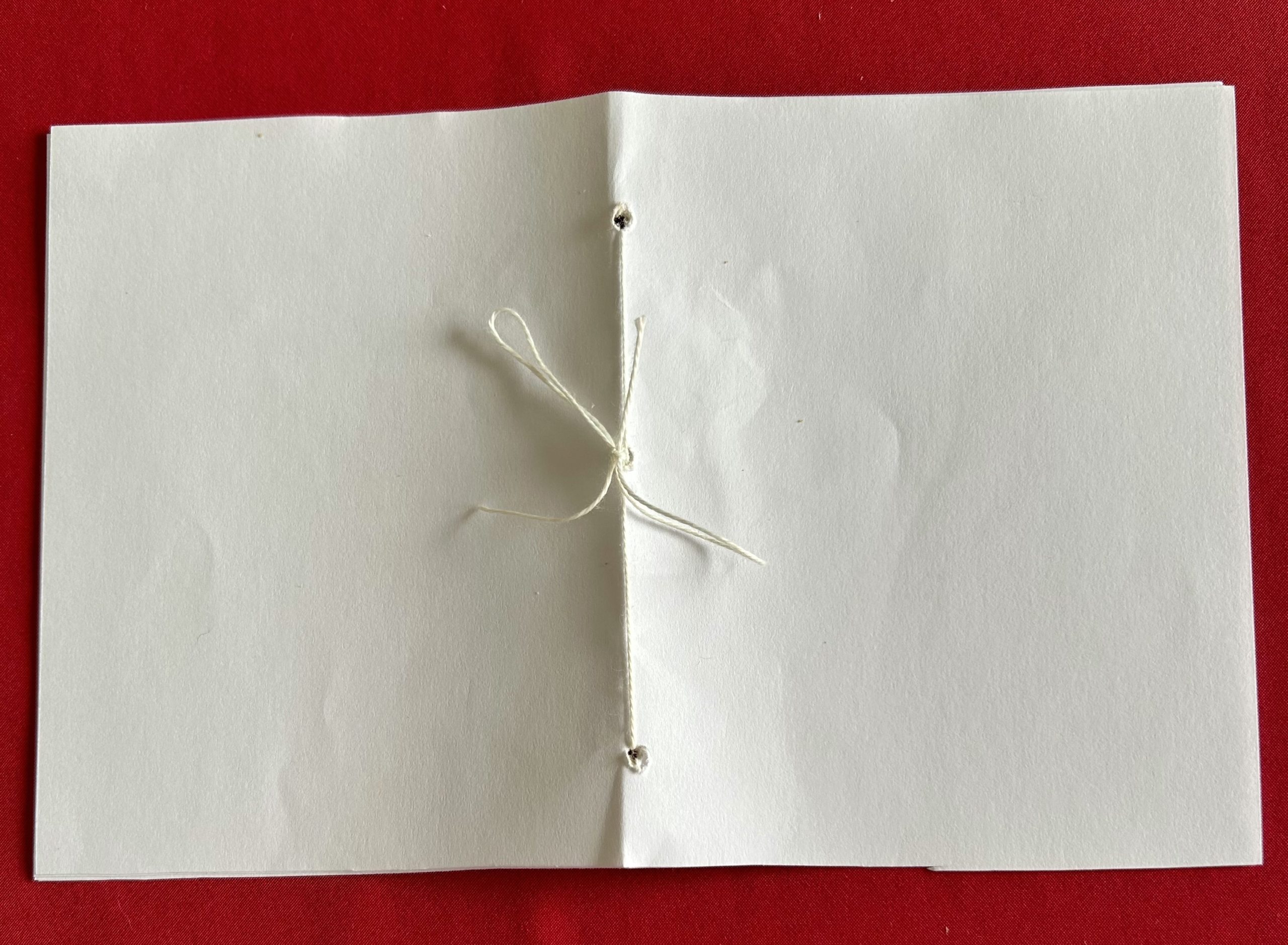 Paper with holes and string in the center