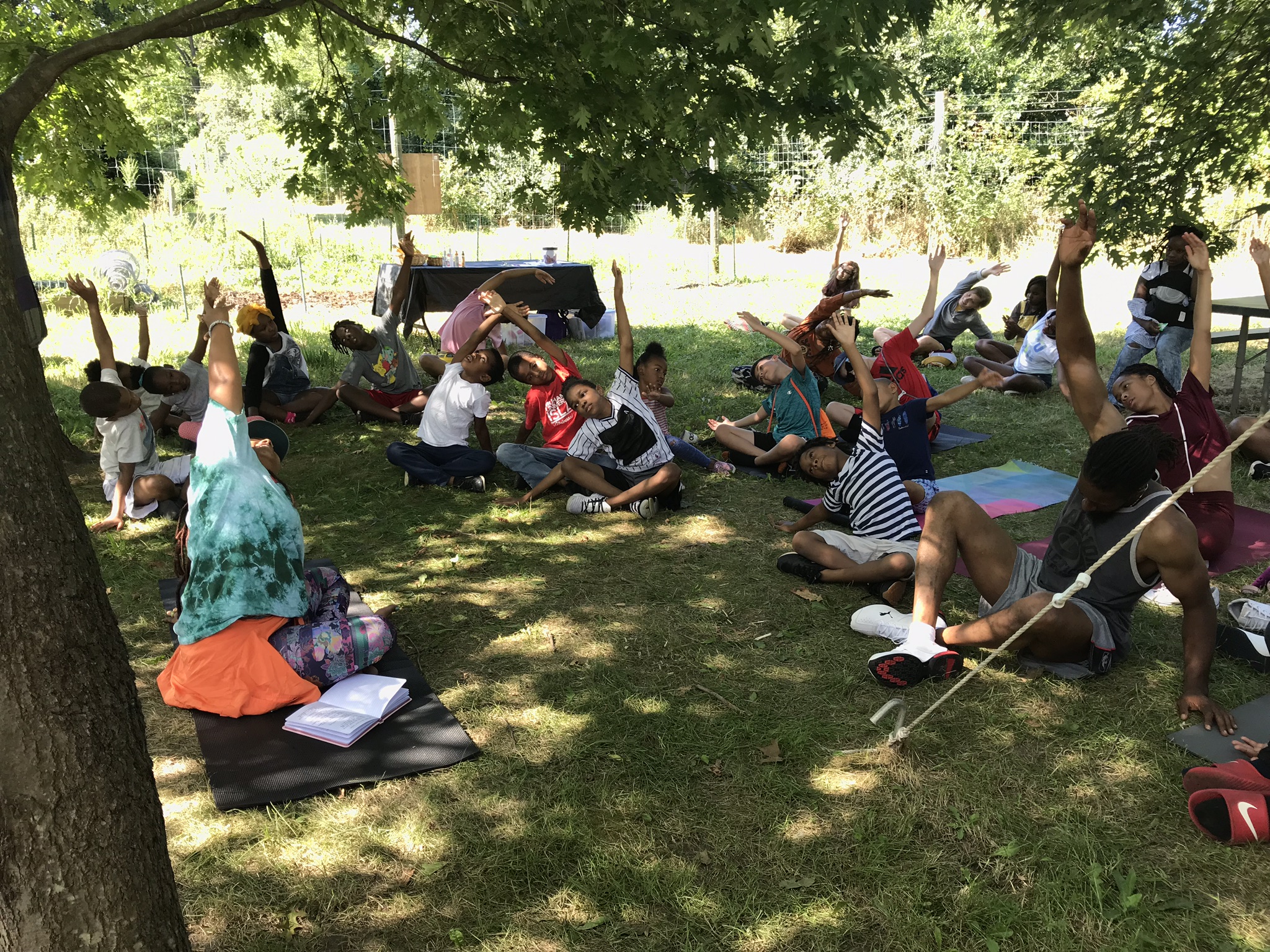 Children doing yoga outside.