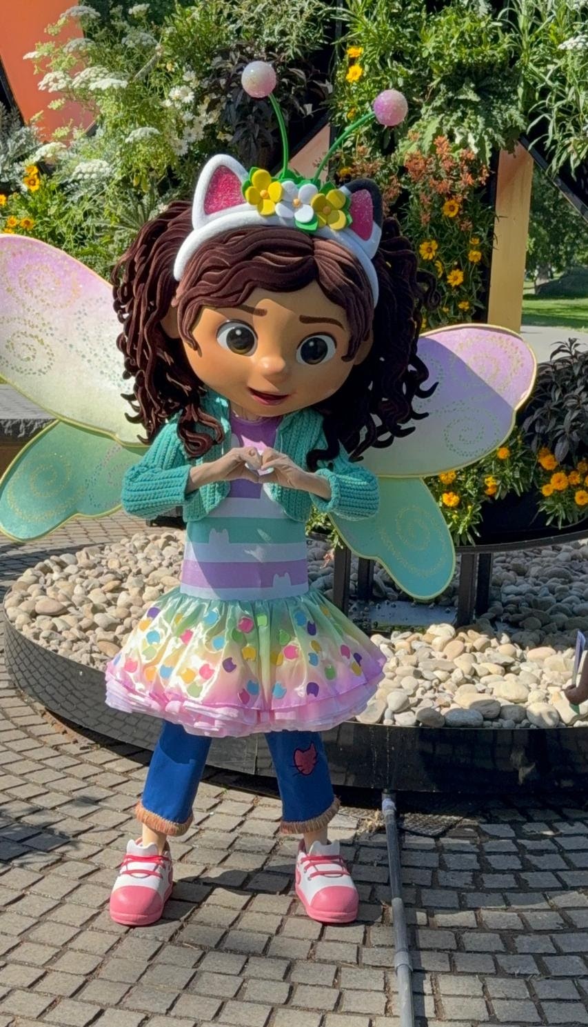 Gabby, the character from Gabby's Dollhouse, live outside in a garden.